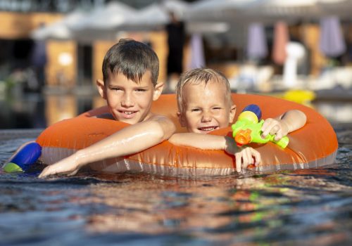 boys-having-fun-swimming-pool-with-pool-float-water-gun boys-having-fun-swimming-pool-with-pool-float-water-gun